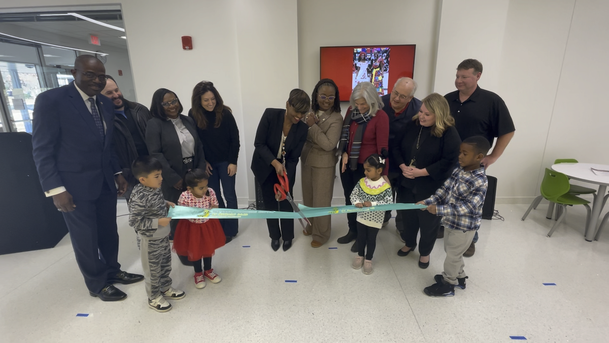 Staff and representatives cut the ribbon to mark the opening of the Early Learning Center.
